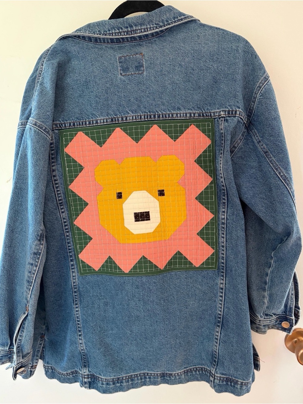 Upcycled vintage Nevada women’s jean jacket with quilted bear patch on the back